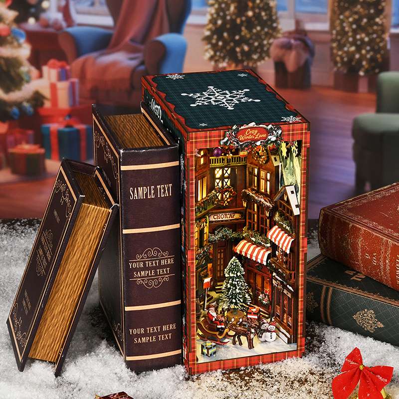 Cozy Christmas village DIY book nook nestled between decorative books as Christmas bookshelf decoration